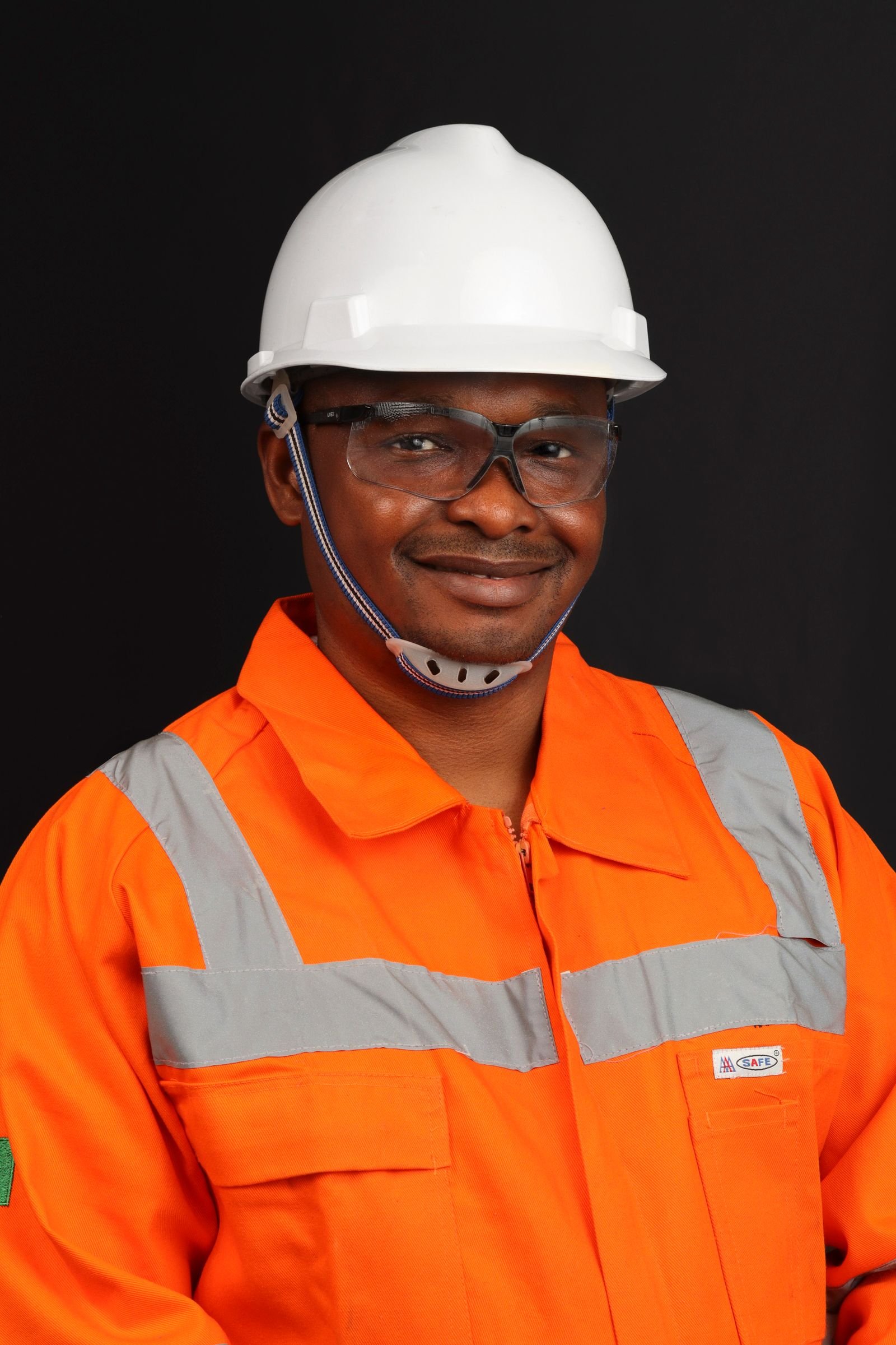 Worker wearing flame-resistant hi-vis coverall and hard hat